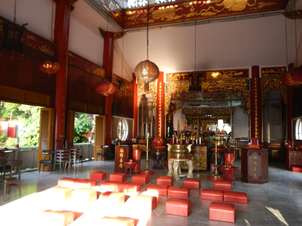 Red lanterns, ornate gold details, and ceremonial furnishings inside Ma-Cho Temple